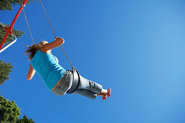 istock Woman swinging on swing 521205094
