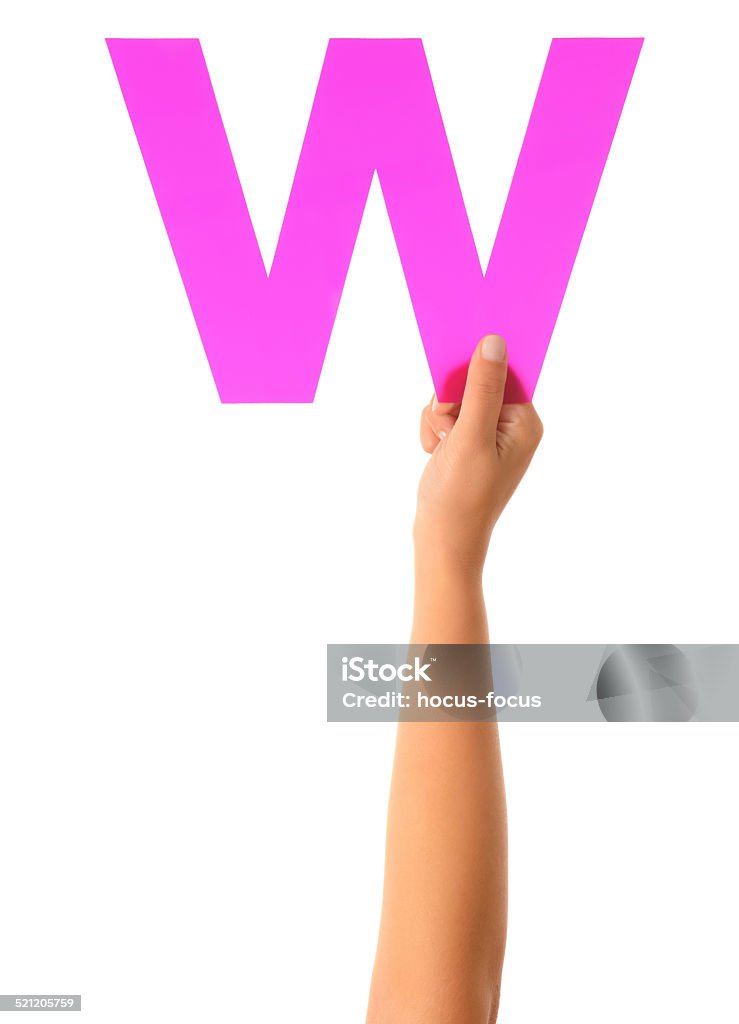 Letter W Woman hand holding a purple letter W. Isolated on white. Adult Stock Photo