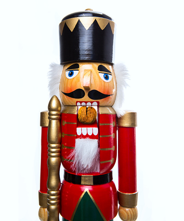 Christmas still life with knick knack nutcracker decoration ornament\nRed and warm orange background, still life with copy space