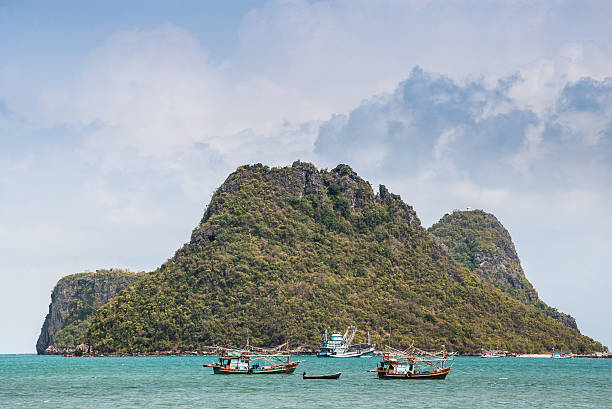 istock Fishing boat moored on the coast sea with mountains. 521207042
