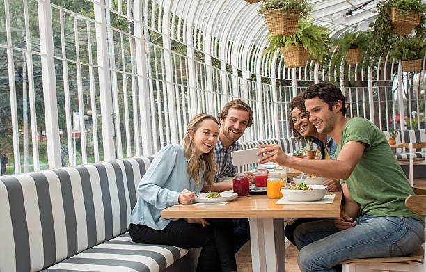 istock Young people taking a selfie at a restaurant 521207106