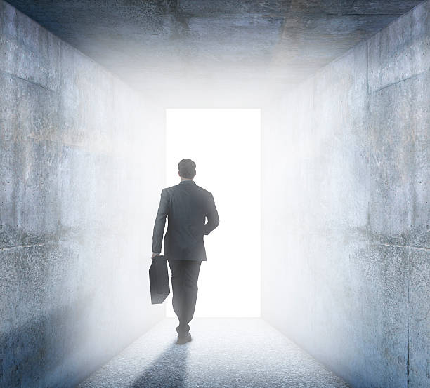 istock Businessman Walks Into The Light Of Opportunity 521207938
