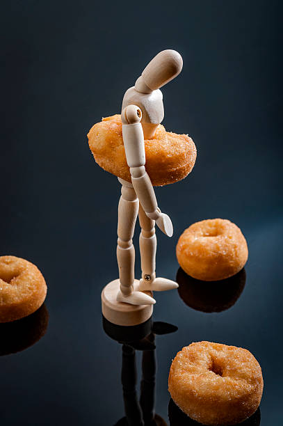 istock Sad and depressed overweight human figurine 521208278