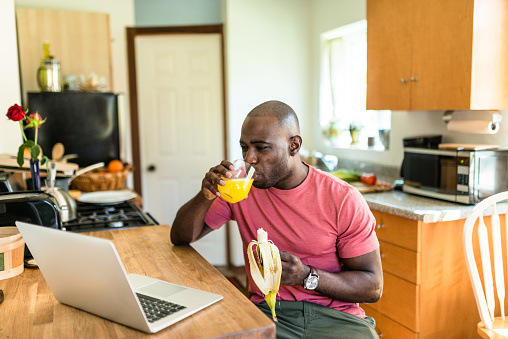 african guy doing the breakfast on the pc