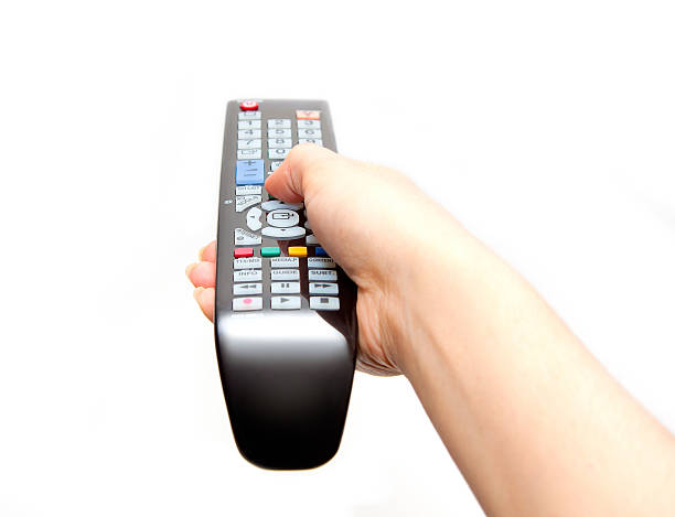Black TV remote in hand black TV remote in hand isolated on white background remote control photos stock pictures, royalty-free photos & images