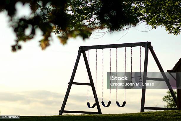 Swingset At Sunset Silhouette Stock Photo - Download Image Now - Back Lit, Childhood, Cloudscape