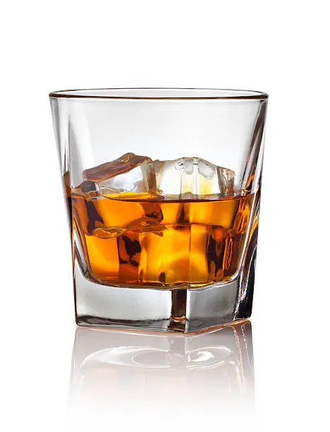 Glass of scotch whiskey and ice on a white background