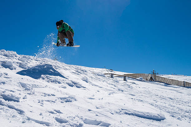 istock Snowboarder jumping against blue sky 521210732