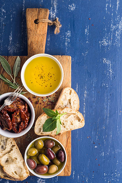 istock Mediterranean snacks set. Olives, oil, herbs and sliced ciabatta bread 521212934
