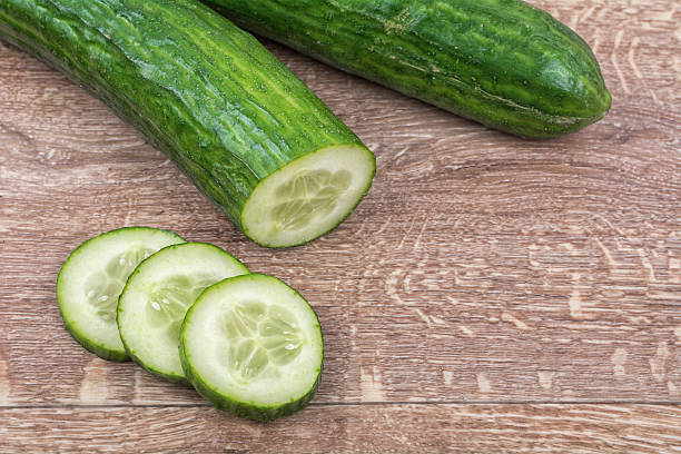 istock Cucumbers on a wooden background 521223174