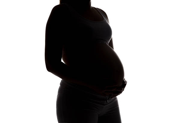 istock Silhouette of future mother half turned, no face 521225188