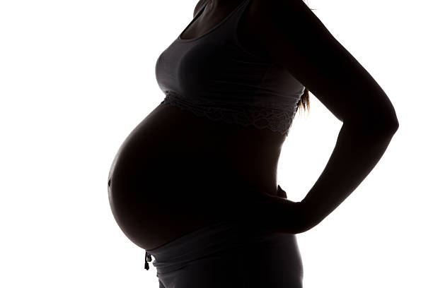 istock Silhouette of future mother in profile, no face 521225210