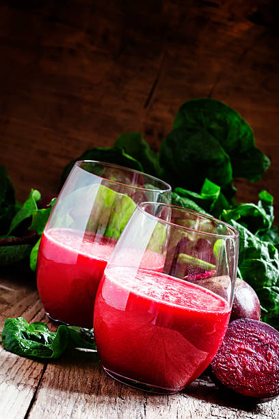 istock Large glasses with red beet juice, fresh beetroot with tops 521225368