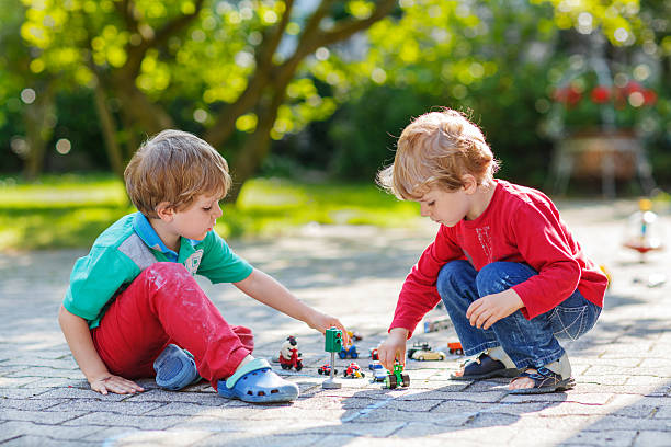 istock Two little boys playing with car toys 521226573