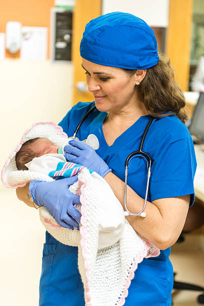 istock Nurse feeding a newborn 521227838