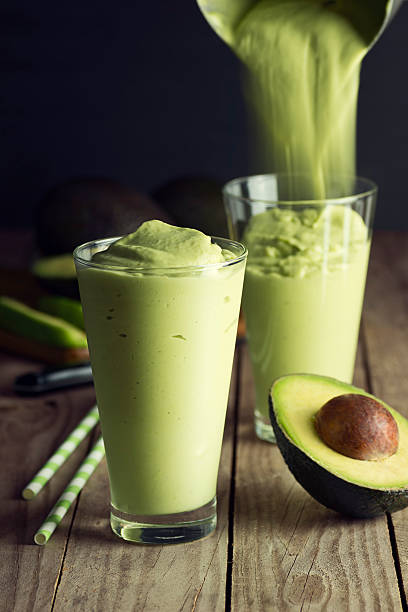 istock Pouring an Avocado Shake into Glasses 521228211