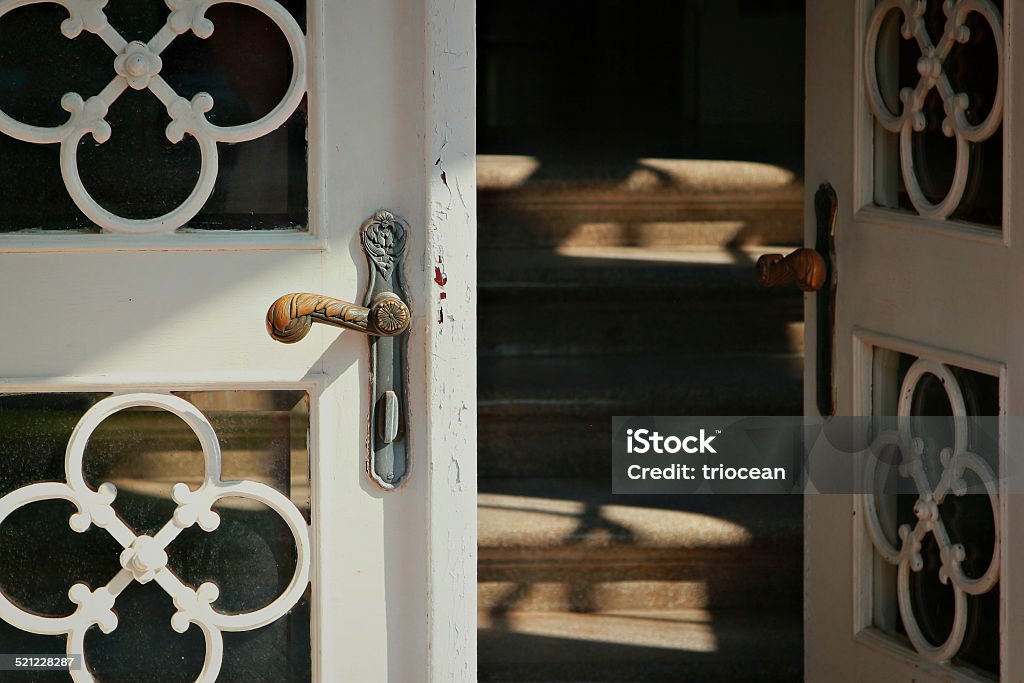 Entrance into the home Close up of the iron door handle on the old wooden door Accessibility Stock Photo