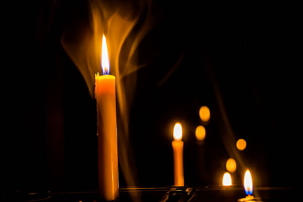 istock Yellow candle on the background with smoke 521229561