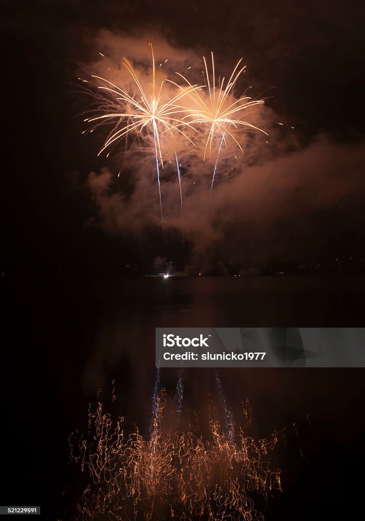 Colorful fireworks on black sky background with water reflections Abstract Stock Photo