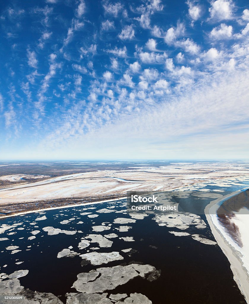 Great river with floating ice floes, top view Aerial view the floating ice blocks which are moving on the great river during the spring day. Drifting of ice. Ice floe. Above Stock Photo
