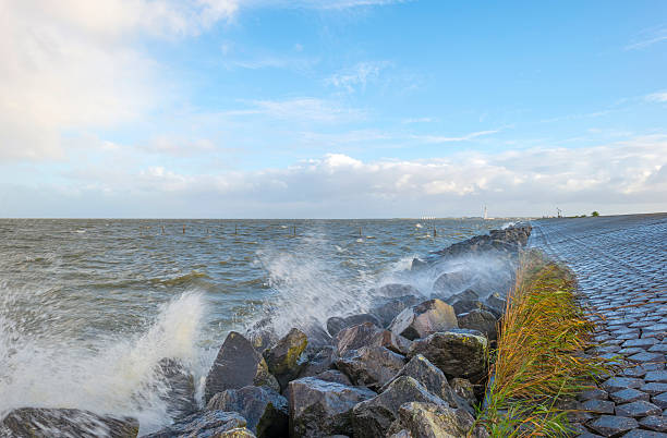 istock Basalt stones along a dike in a stormy sea 521233049