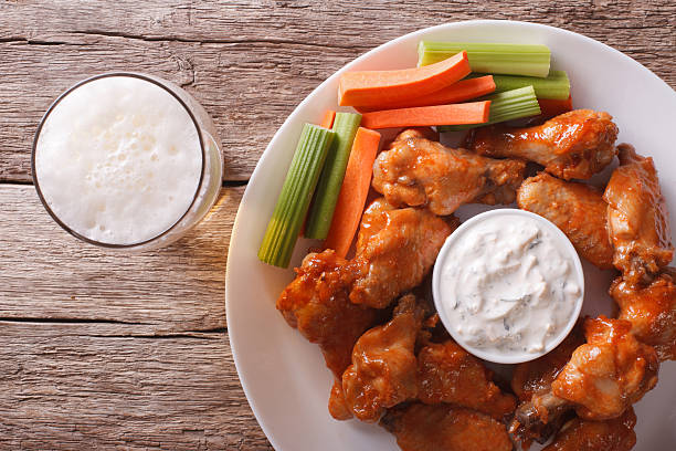 istock American fast food: buffalo wings and beer closeup horizontal 521233072