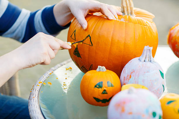 istock Hollowing out a pumpkin to prepare halloween lantern 521233453