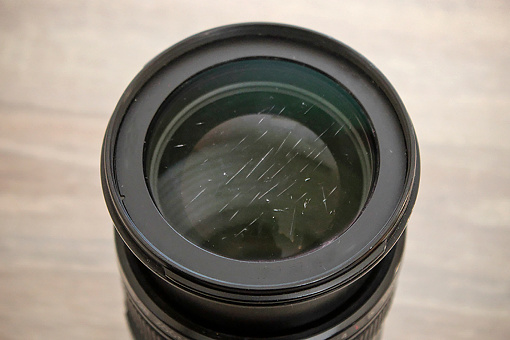 Close-up of scratched zoom lens glass.