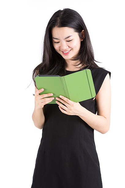 Asian lady reading an ebook reader stock photo