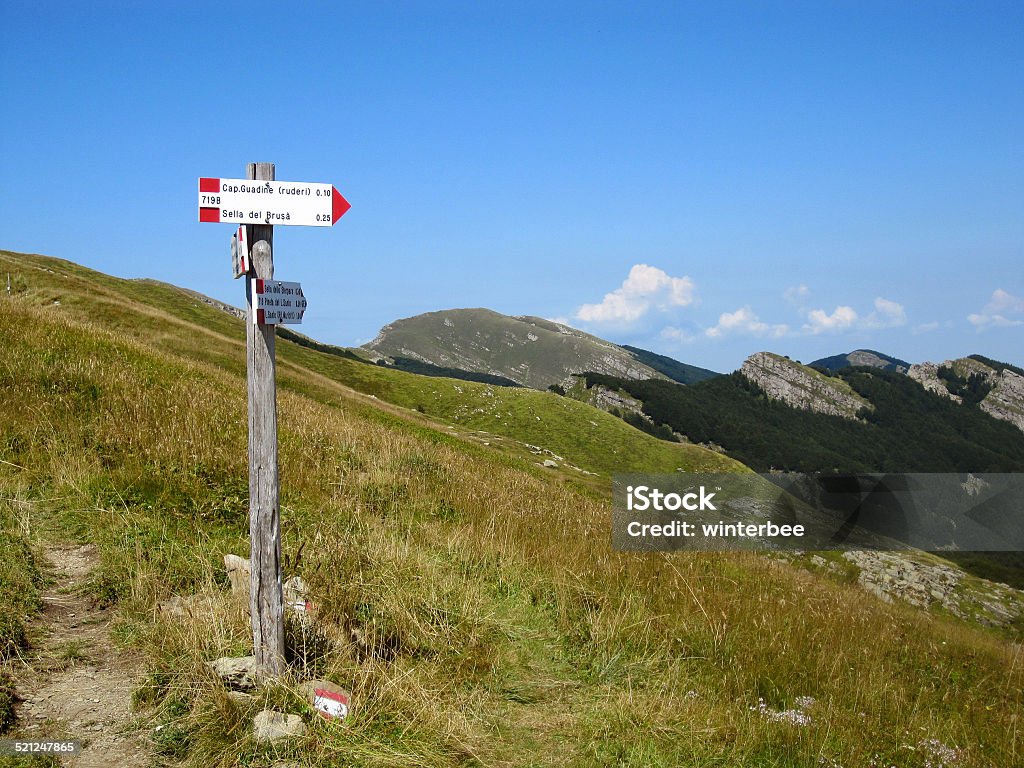 Signpost in Italian mountains A tourist signpost showing directions in the Apennines. Apennines Stock Photo