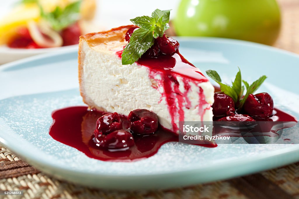 Dessert - Cheesecake Dessert - Cheesecake with Berries Sauce and Green Mint Baked Pastry Item Stock Photo