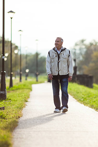 istock Happy senior man walking on the promenade 521250133