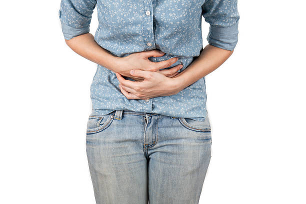 istock Young beautiful woman is having stomach ache. Isolated on white. 521261014