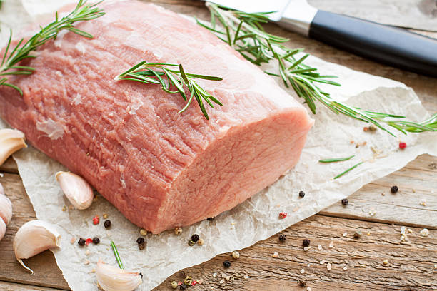 Raw veal tenderloin on wooden table