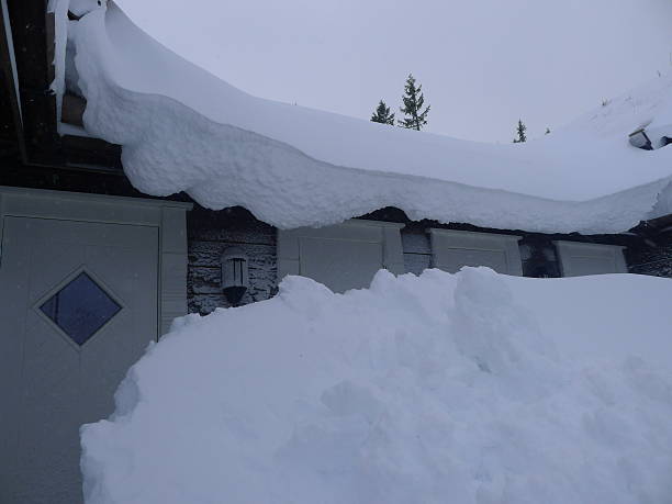istock winter cabin and lots of snow 521261663