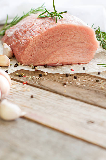 istock Raw veal tenderloin on wooden table 521261674