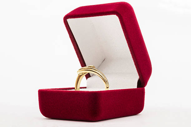 istock Golden ring in red purple jewelry box 521261815