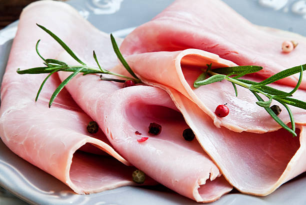 Ham Slices with Rosemary Ham Slices with Rosemary and Peppercorns, Italian Ham Speciality cooked bacon slice stock pictures, royalty-free photos & images