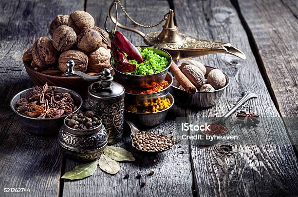 Spices And Nuts At Wooden Table Stock Photo - Download Image Now - Ayurveda, Food, Spice