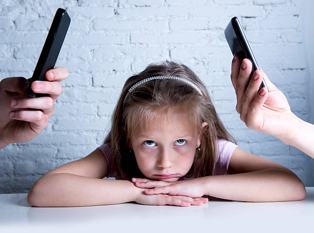 addict mobile phone parents neglecting daughter ignored and bored stock photo