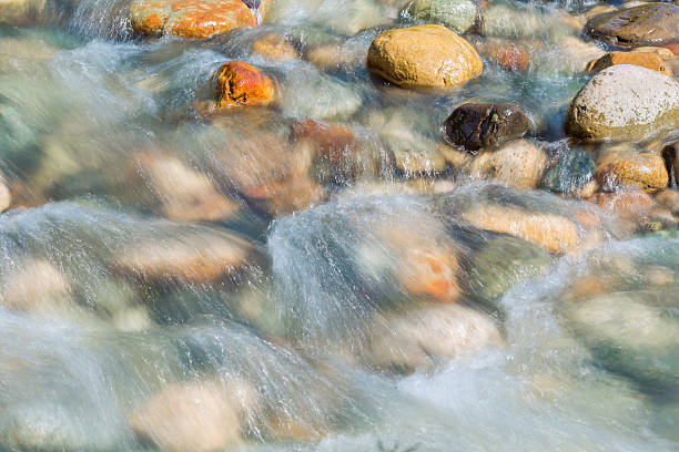 istock Pebble stones in the river water close up view, 521263718