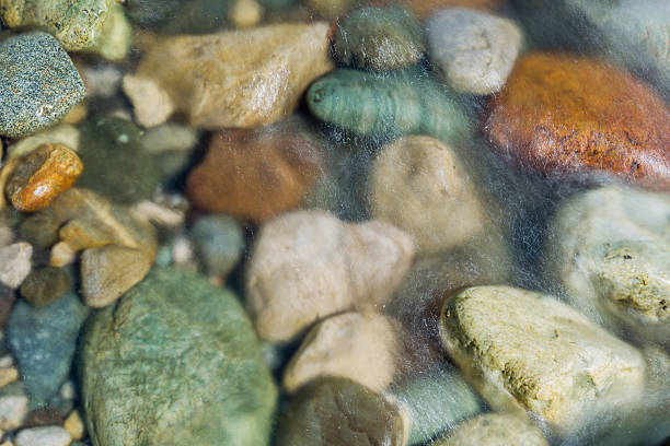 istock Pebble stones in the river water close up view, 521263766