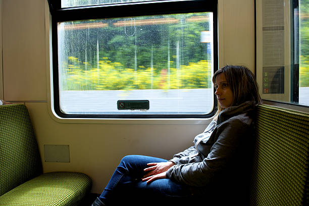istock young woman sitting front to the wagon window 521263903