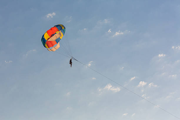 istock Man parasailing over the sea 521263982