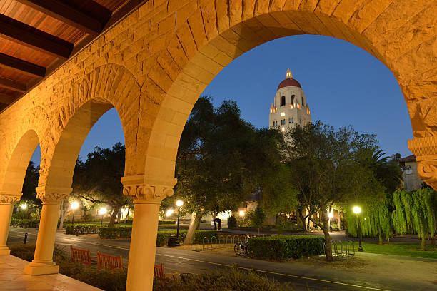 Night View of Stanford University Campus Stanford, USA - September 22, 2014. View of Hoover Tower through arched door in the campus of Stanford University at night. Stanford University is a world famous private research and teaching university located in Stanford, California. It was founded in 1885 in a suburban setting. stanford university photos stock pictures, royalty-free photos & images