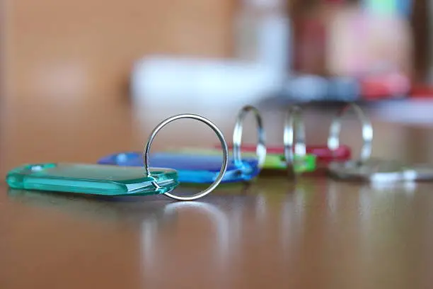 Close up on several colorful keyholders with key on office desk