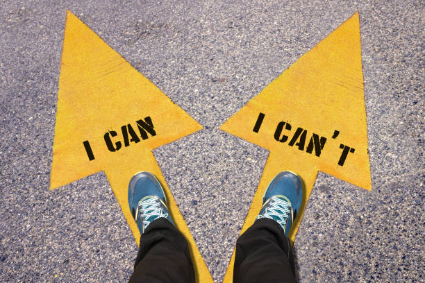 istock I Can and I Can't  painted on road 521265236