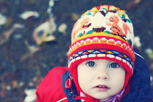 istock Blue-eyed kid in the hat looks up 521265298