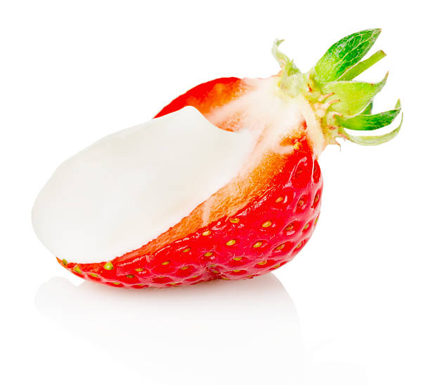 istock half of strawberry with cream  on the white background 521265487
