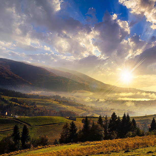 istock village on hillside meadow with forest in mountain at sunset 521265845